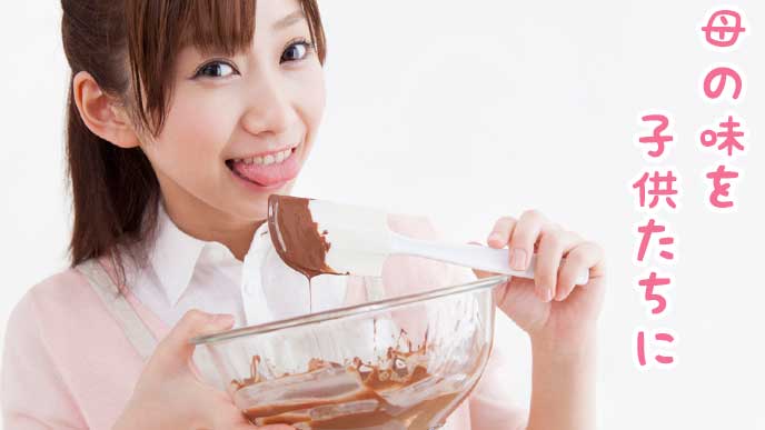 お菓子作りでチョコレートの味見をする主婦